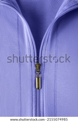 Half zipped cotton sweatshirt hoodie close-up. Fashionable summer blue violet jacket with zipper fastening. Casual outerwear and clothes in trendy color 2022 very peri. Zip fastener of pullover. Macro Royalty-Free Stock Photo #2155074985