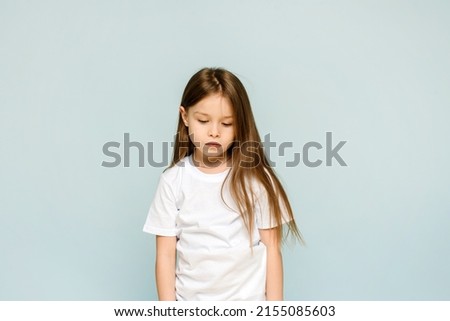 Photo of unhappy sad upset little girl feeling bored offended isolated on blue background Royalty-Free Stock Photo #2155085603