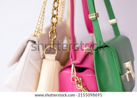 woman hand holding set of colorful bags. Product composition photography. handbag and purse for women.