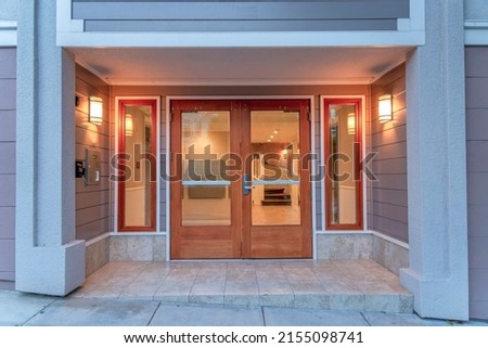 Double door with glass and wood frames of a modern apartment building at San Francisco, CA Royalty-Free Stock Photo #2155098741