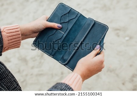leather wallet in hand with cards