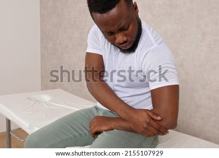 Man With Pain In Elbow. Arthritis , joint injury concept.