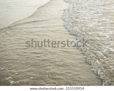 an image of sea wave on sand at shore