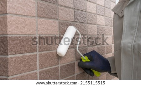 A man repairing the outer wall. Royalty-Free Stock Photo #2155115515