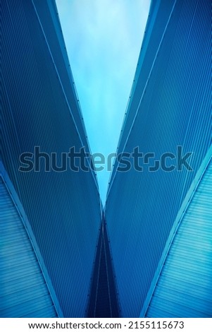 Overpass, view from below. Abstract modern architecture. Closeup photo resembling walls and roof of hi-tech building. Industrial real estate object. Triangular or polygonal geometric structure.