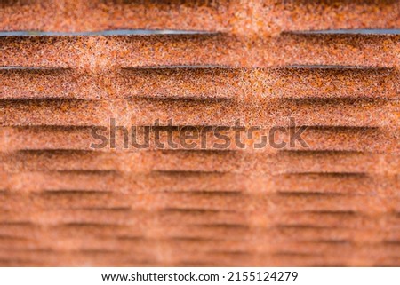 Abstract background dynamic perspective of a rusty iron fence with narrow depth of field