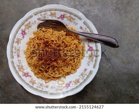 Mie goreng. Instant noodles. Fried noodles. Fried noodles are placed on a plate. Fried noodles from Indonesia. High angle view.