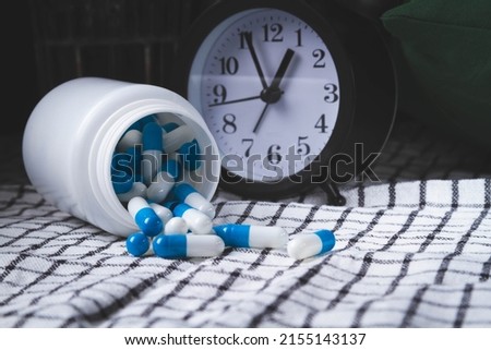 Time to take your medicine. Pill reminder. Tablets and alarm clock. Notification of the doctor about the prevention of the disease.