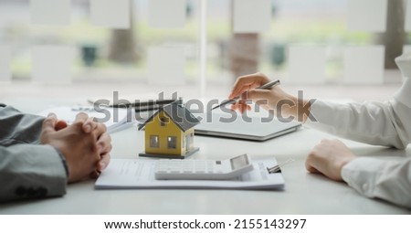 Real estate broker agent being analysis and making the decision a home estate loan to customer to signing contract documents for realty purchase, get insurance or loan real estate or property. 