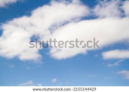 Cumulus clouds. White clouds on a blue background. Summer sky.