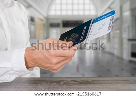 Male passenger giving US passport and tickets for inspection at checkpoint custom counter Royalty-Free Stock Photo #2155160617