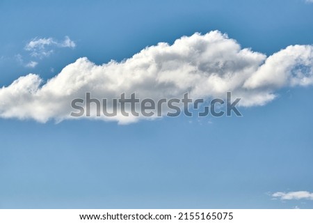 Isolated clouds on a clear sky of a strong blue color