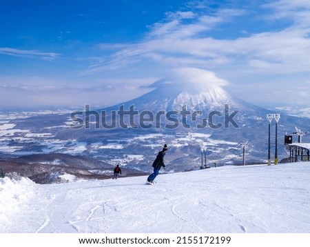 Snowy volcano with cap cloud viewed from a ski resort (Niseko, Hokkaido, Japan)