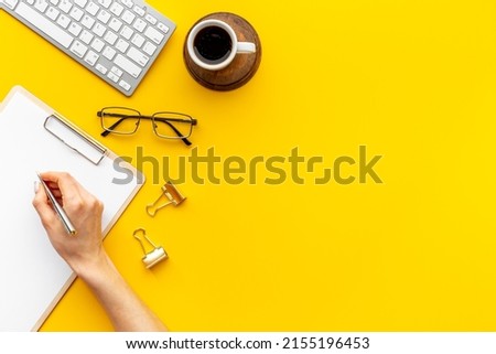 Woman hands working with computer on office table, top view