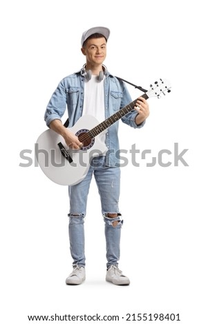 Handsome guy playing an acoustic guitar isolated on white background