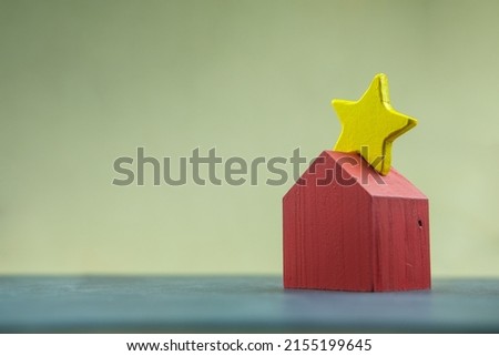 Wooden star yellow on roof a wood red home it mean ranking the best home. The concept of ranking house.