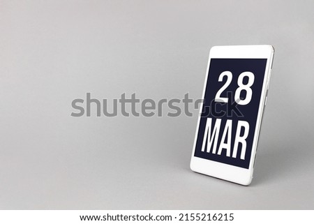 March 28th. Day 28 of month, Calendar date. Smartphone with calendar day, calendar display on your smartphone.  Spring month, day of the year concept