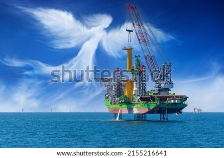 Offshore wind construction vessel at work Royalty-Free Stock Photo #2155216641