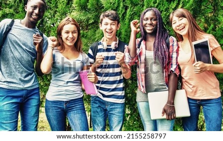 Happy group of african, asian and caucasin teenagers enjoying outdoor time standing in a park. Royalty-Free Stock Photo #2155258797