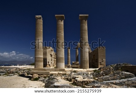 Picture remains of ancient Greece ,look the formation of those pillers and the serinity of the cloud behind them making the monuments to stand out and beautiful to look at.