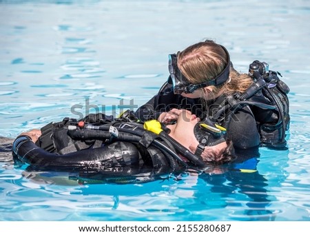 Scuba Diving rescue course surface skills checking for breathing of an unconscious diver Royalty-Free Stock Photo #2155280687