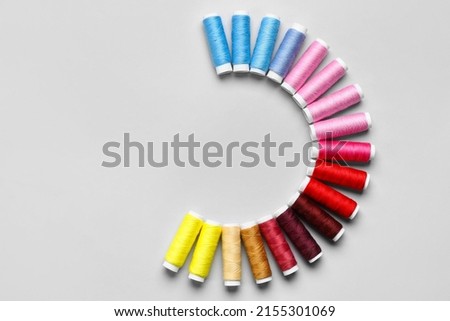 Sewing threads on light background