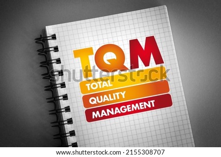 TQM - Total Quality Management acronym on notepad, business concept background Royalty-Free Stock Photo #2155308707