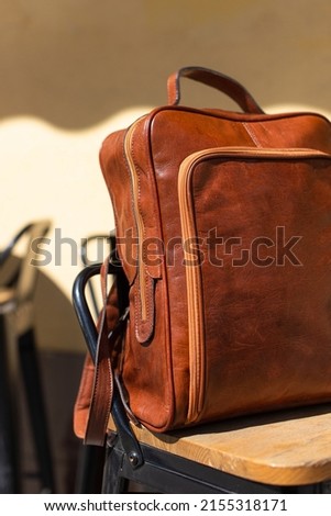 Orange leather backpack. Street photo. Natural light