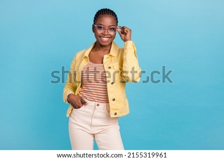 Portrait of attractive skilled cheerful girl posing touching specs isolated over bright blue color background Royalty-Free Stock Photo #2155319961