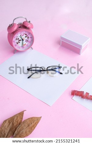 Fashion and beauty concept lying flat with glasses, women's accessories on pink background. Product Presentation of Minimalist Concept Ideas
