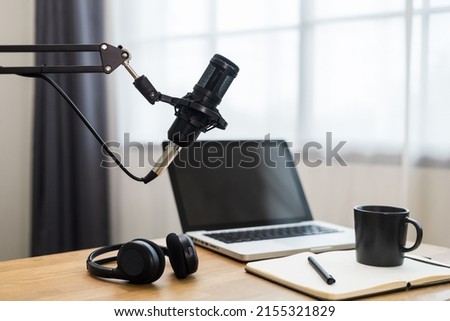 Condenser microphone in recording home studio. Content creator working with laptop host streaming radio podcast interview conversation at home broadcast studio recording voice over radio