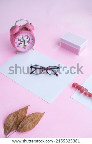 Fashion and beauty concept lying flat with cat eye glasses, women's accessories on pink background. Product Presentation of Minimalist Concept Ideas

