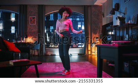 Portrait of Diverse Multiethnic Young Latin Female Dancing in Futuristic Neon Glowing Glasses, Having a Party at Home in Loft Apartment. Recording Funny Viral Videos for Social Media.