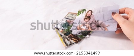 woman sitting at desk and looking at printed photos, remember nostalgia for a day of rest. photography cards, background. Mock up. banner