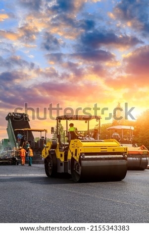Construction site is laying new asphalt pavement. road construction workers and road construction machinery scenery. Highway construction site scene in China. Royalty-Free Stock Photo #2155343383
