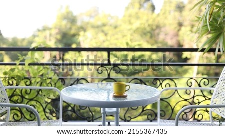 yellow coffee cup on white glass table outdoor