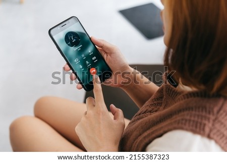 Young woman speaking with stranger man at home. Prank caller, scammer or stranger, privacy, fraud, romance scam. Royalty-Free Stock Photo #2155387323