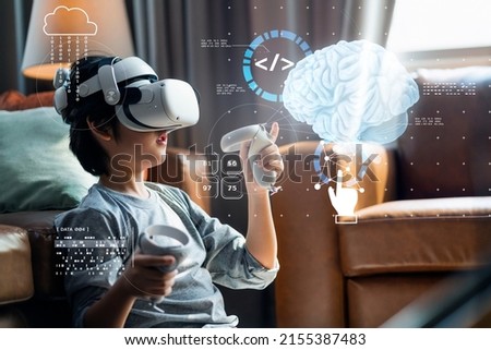 Asian Little boy with VR glasses studying Human body path simulation sciences at home,curious student wears a virtual reality headset to study science home online study futuristic lifestyle learning Royalty-Free Stock Photo #2155387483