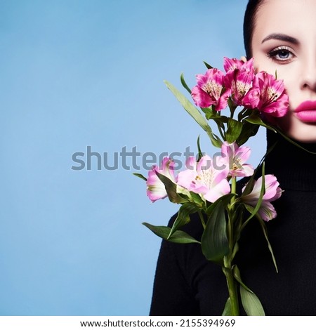  A high fashion model with spring and summer colors. A woman in a colorful bright blue and purple light, posing in a studio, a beautiful girl, colorful makeup.                                Royalty-Free Stock Photo #2155394969