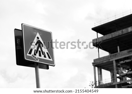 pedestrian crossing sign in front of a ruined building on the Tiber in Rome