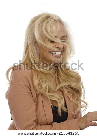 Businesswoman laughing, wind blowing her hair.