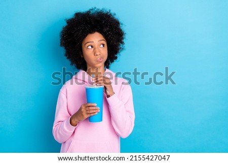 Photo of young girl look empty space curious unsure think drink cola isolated over blue color background Royalty-Free Stock Photo #2155427047