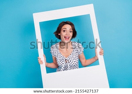 Photo of funky positive person hold paper photo card border isolated on blue color background Royalty-Free Stock Photo #2155427137
