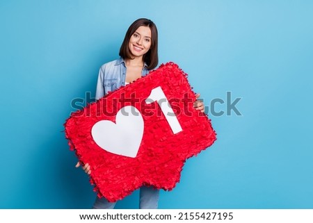 Photo of sweet charming lady dressed denim shirt holding heart like sign isolated blue color background