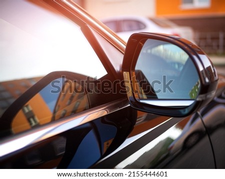 Anti-glare rearview mirror on a black car. safe driving, adjustment of car mirrors