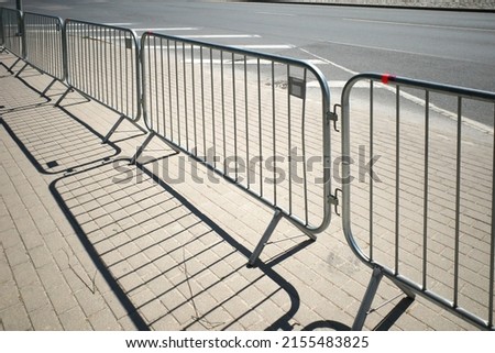 Portable sectional fence. Steel mobile fence on the street. Police fence. Royalty-Free Stock Photo #2155483825