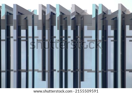 Double exposure photo of framed windows. Structural glazing. Office building with glass wall. Modern architecture viewed in perspective from below. Material construction with steel and glass pattern.
