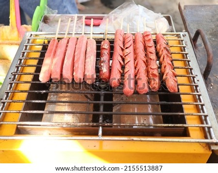 grilled sausage that is in the process of roasting