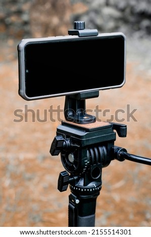 smartphone on monopod on blurred background. smartphone photography