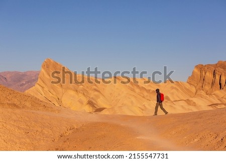 Tourist in Zabriski point in USA, Death Valley National Park, California Royalty-Free Stock Photo #2155547731